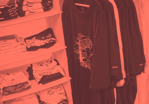 Clothing hanger with handmade and hand screen printed organic cotton t-shirts and tote bags